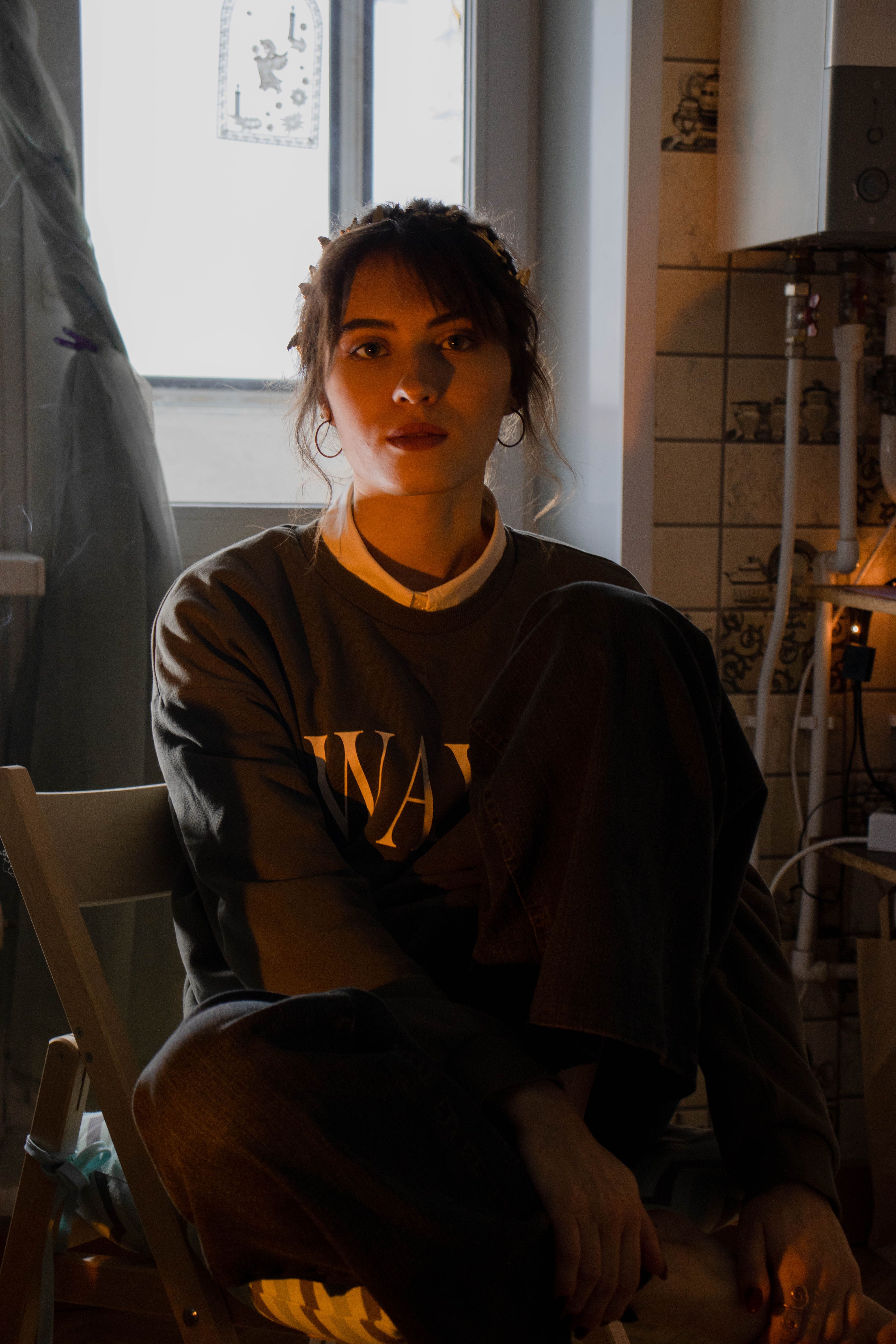 A Woman in a Sweater Sitting on Chair · Free Stock Photo