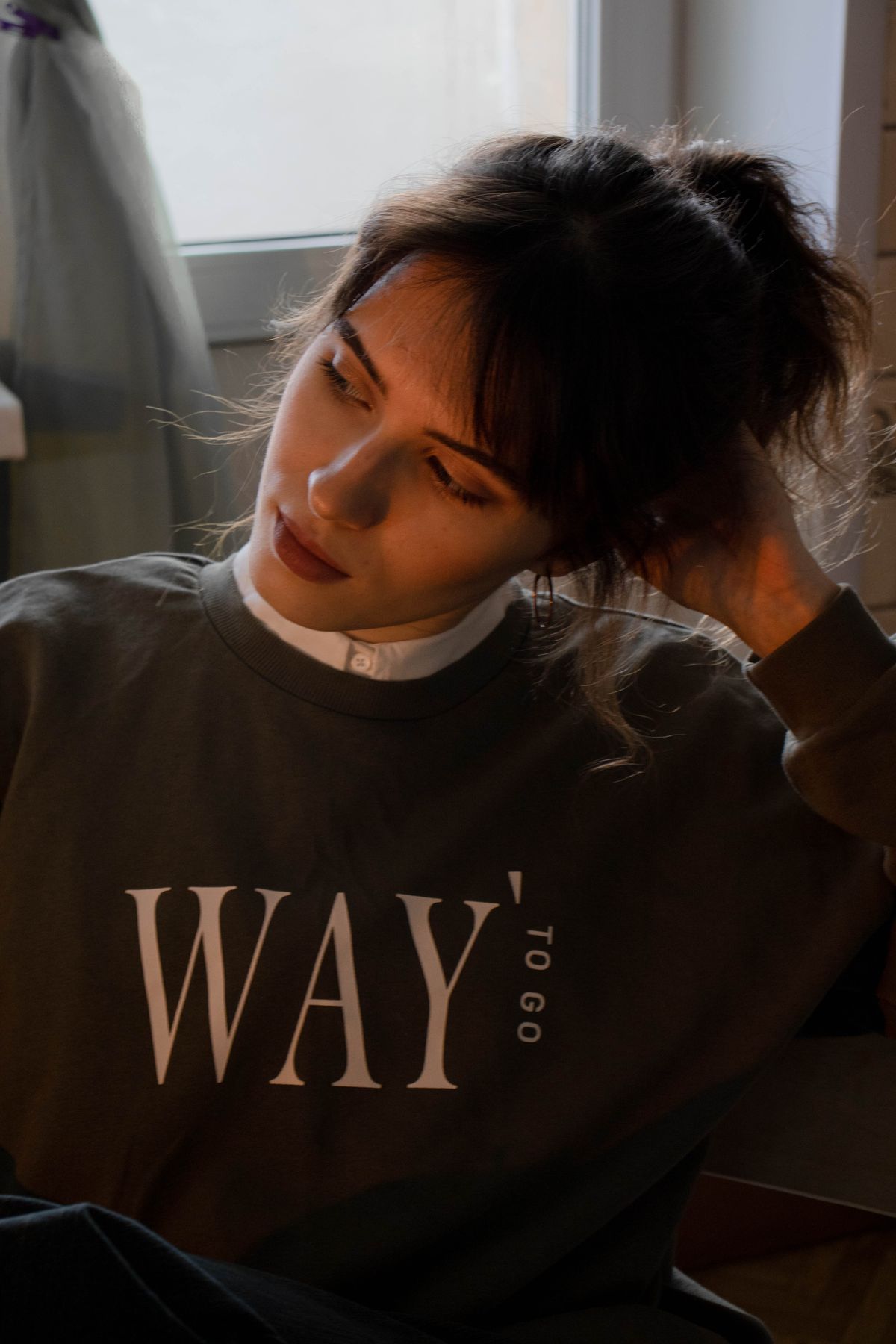 woman wearing green crewneck sweatshirt styled for curvy fall layering