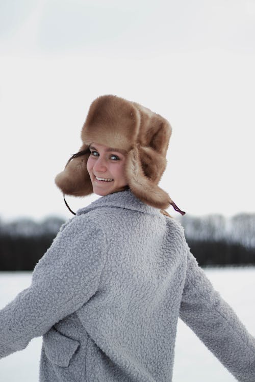 Woman Wearing Warm Clothing on Winter Landscape