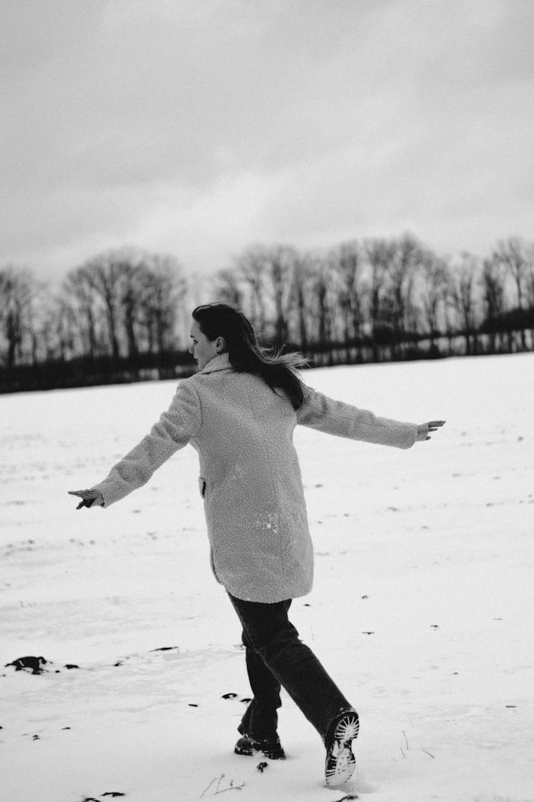 Woman Running On A Field In Snow 