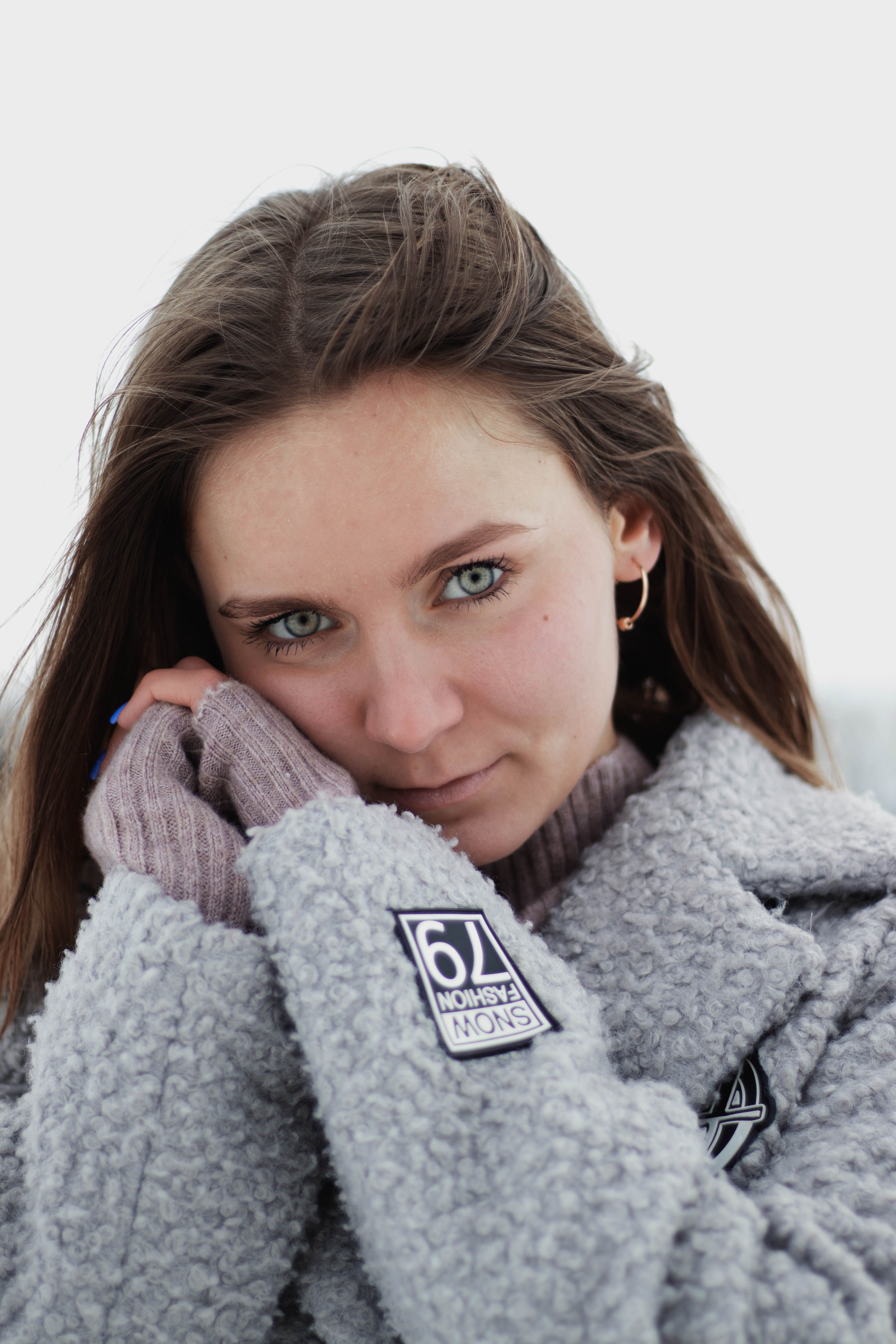 Young woman in a warm wool coat posing outdoors during winter.