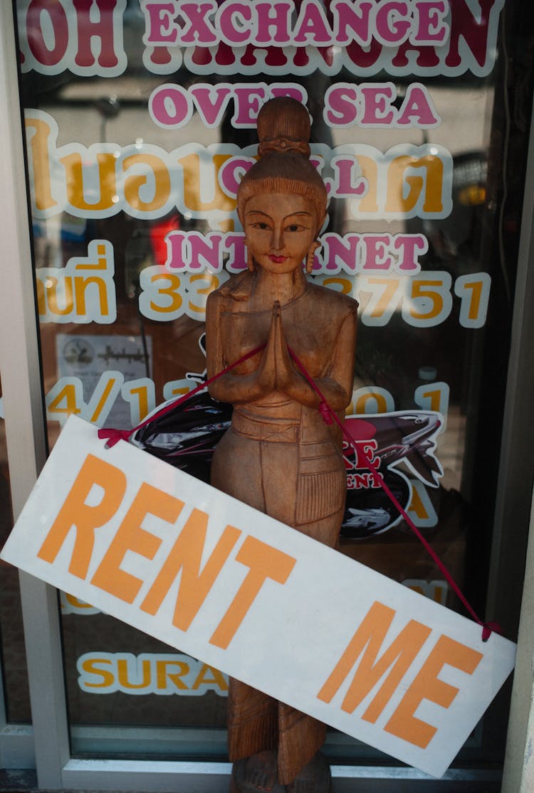 Wooden Figure With Advertising Signboard