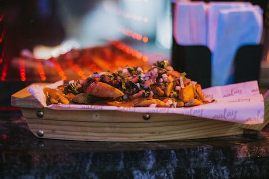 Mouth-watering potato wedges served in a stylish wooden dish with savory toppings and fresh herbs.