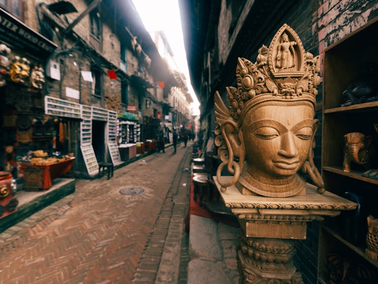 Wooden Column With Goddess Head On Market Street