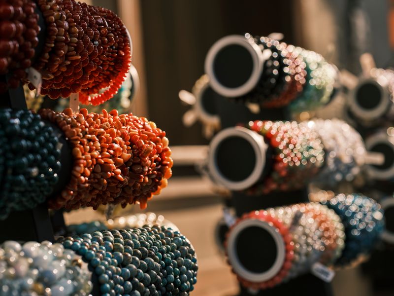 Colorful handmade beaded bracelets on display, reference style