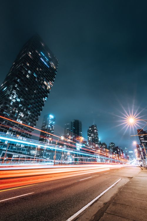 Free Vibrant Vancouver cityscape at night showcasing dynamic light trails and modern skyscrapers. Stock Photo