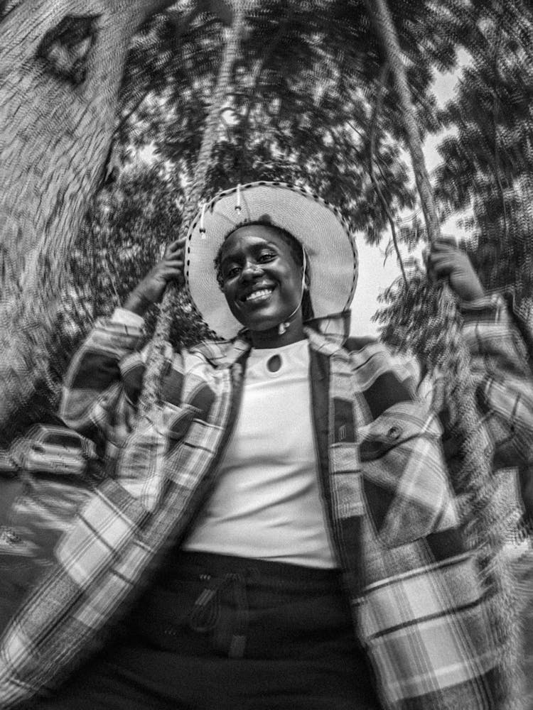 Black And White Photo Of A Woman On A Swing