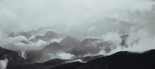 Free Fog envelops the majestic mountain range in Xinzhou, Shanxi, China, creating a mystical atmosphere. Stock Photo