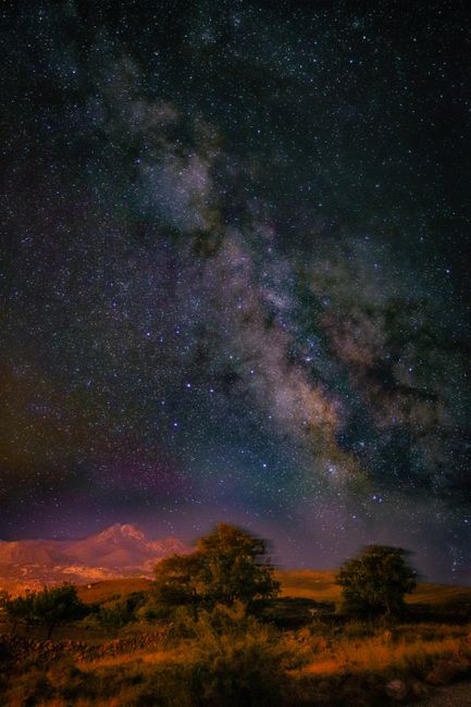 Beautiful starry night sky featuring the Milky Way galaxy above a scenic landscape.