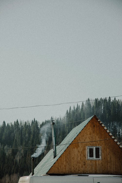 Smoke Coming From the Wooden House Chimneys 