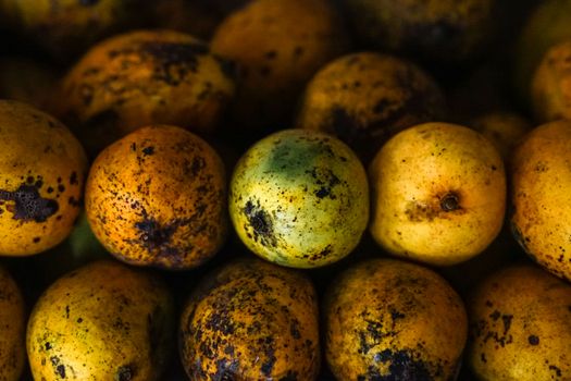 Detailed closeup of ripe yellow mangoes showing texture and natural blemishes.