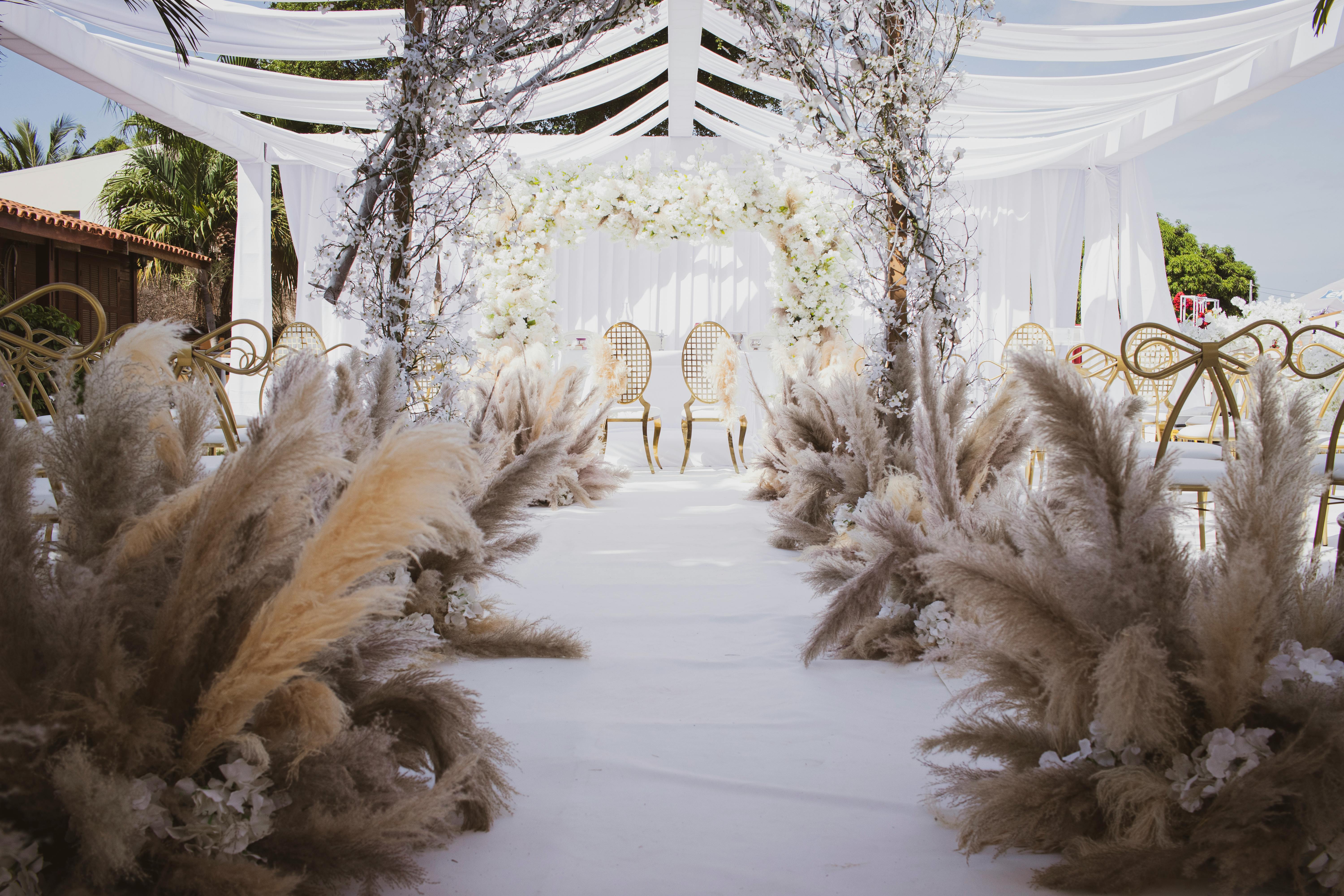 Beautifully arranged outdoor wedding ceremony with floral decorations and elegant chairs in Angola.