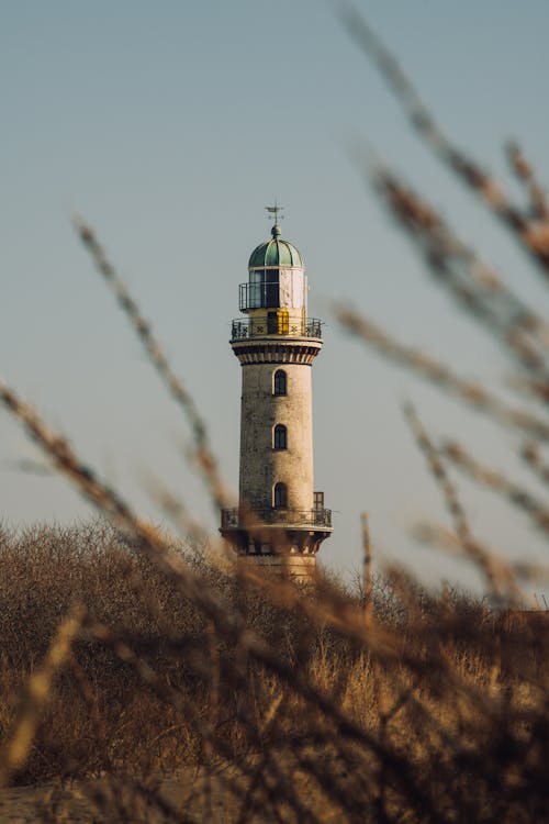 Lighthouse on Grass Field