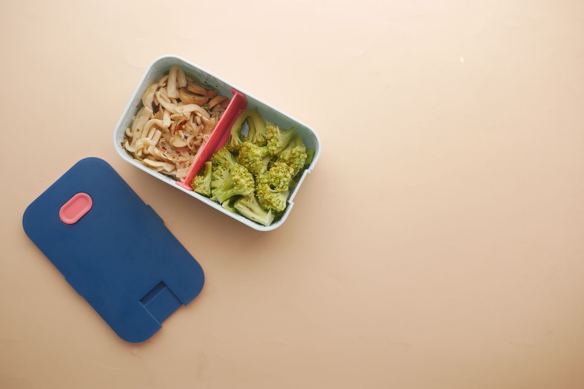 Meal-prep container with pasta and roasted broccoli sealed for the fridge