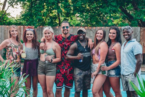 Free A diverse group of young adults having fun at a summer pool party outdoors, smiling and relaxed. Stock Photo