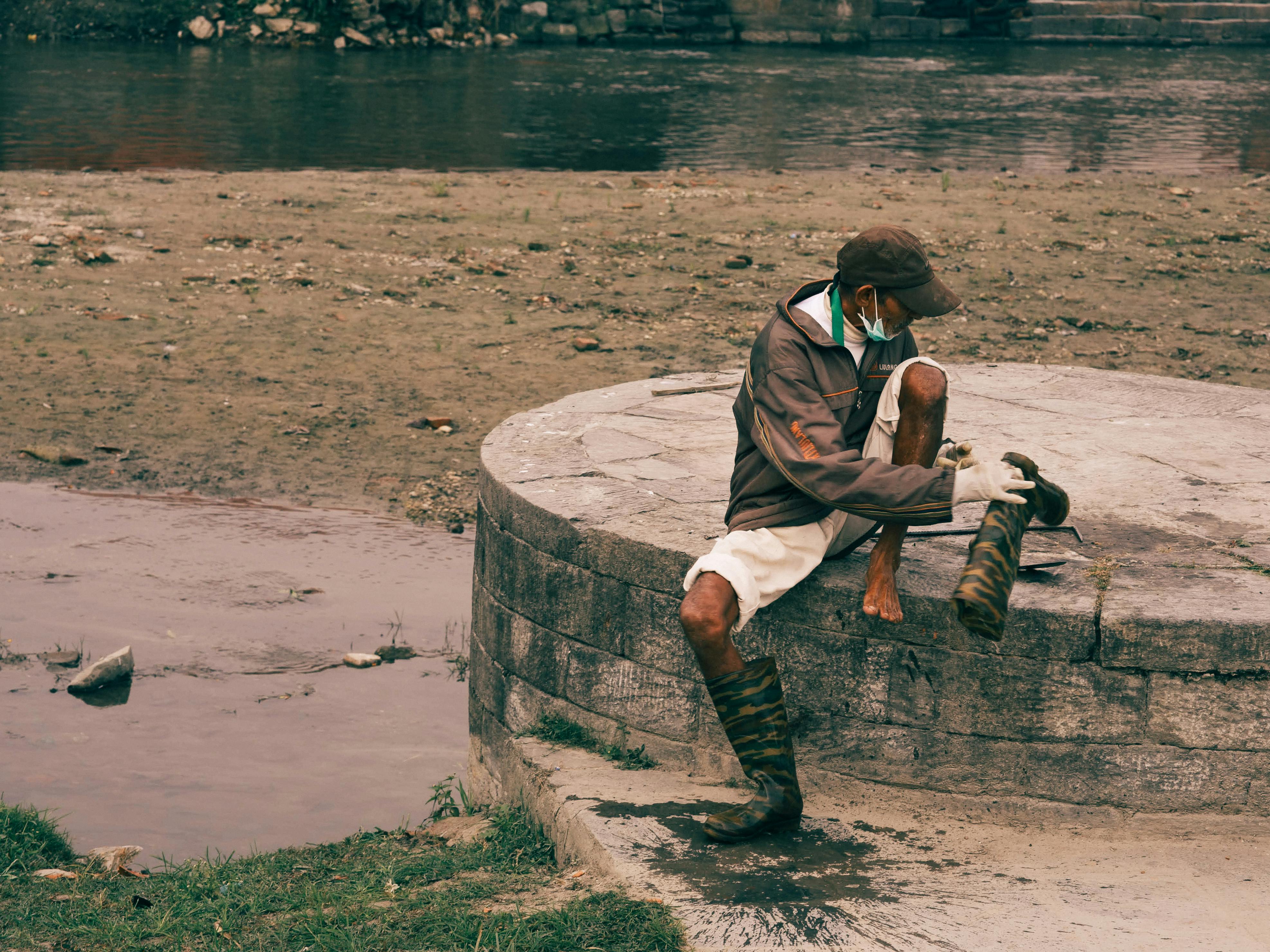A Man Putting on Boots · Free Stock Photo