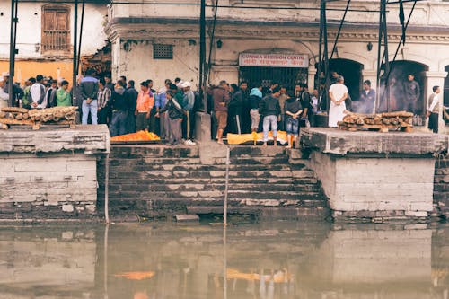 Man Standing Between River and Building