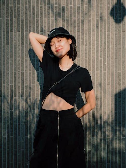 Free Woman in Black Clothes Wearing a Bucket Hat Stock Photo