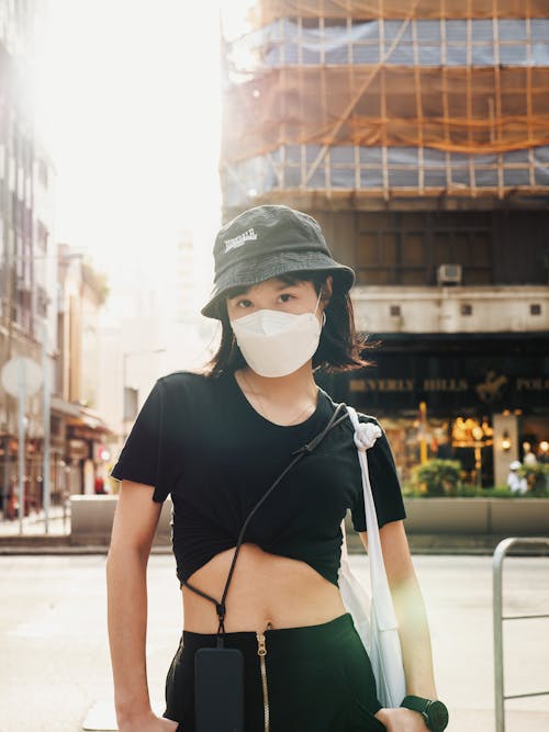 Woman in Black Crop Top Wearing a Face Mask