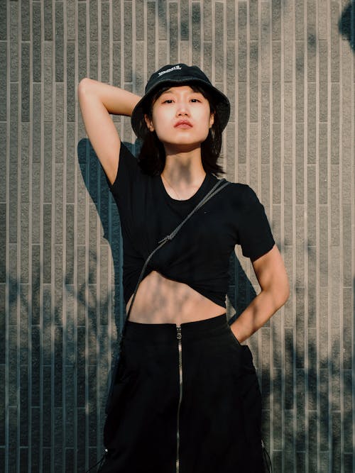Free Woman Wearing Black Crop Top and a Bucket Hat Stock Photo