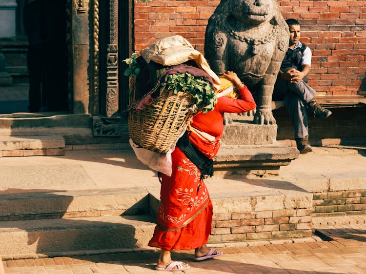 Woman Carrying A Heavy Basket