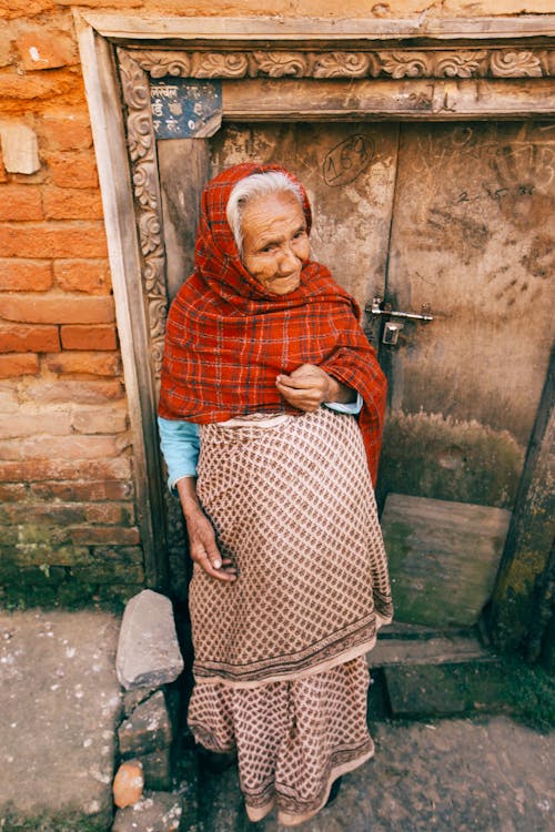 Elderly Woman Standing Near Door