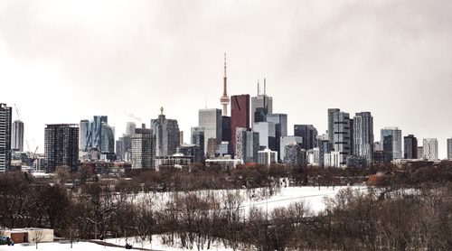Free Aerial view of Toronto's skyline in winter with snow-covered ground and the CN Tower. Stock Photo