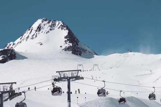Scenic view of snow-covered mountains and cable cars at Soelden ski resort in winter.