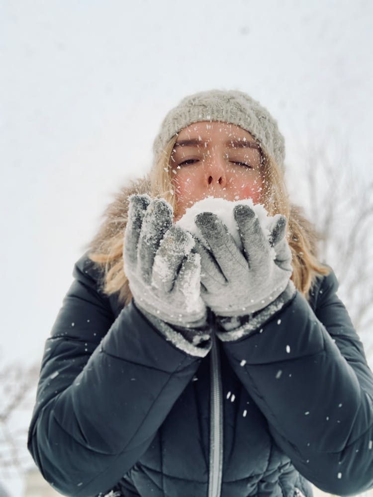 A Woman Blowing Snow 