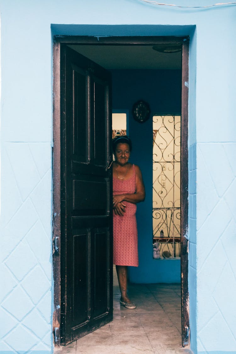 Woman Standing In House With Open Doors