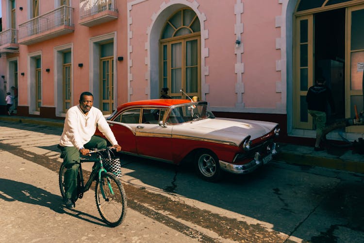 Man Riding Bicycle On City Street