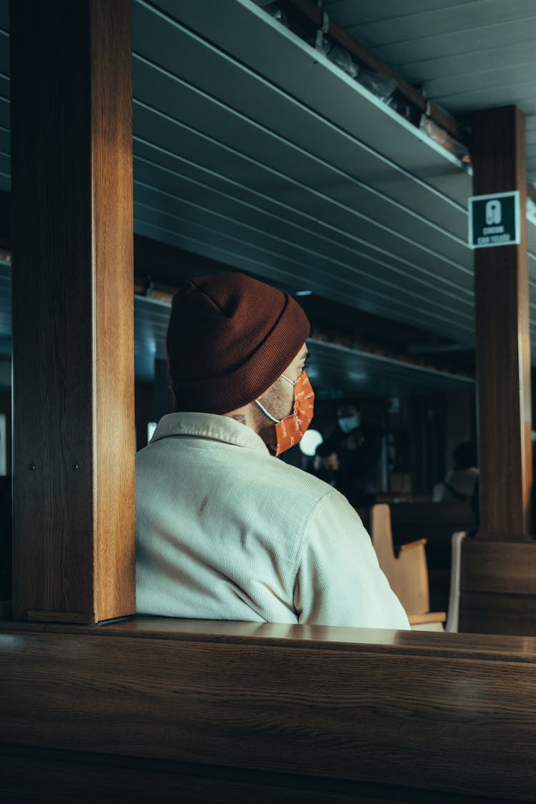 Man Sitting In Cafe In Face Mask