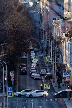 Busy Moscow street with heavy traffic and pedestrians, captured during daytime.