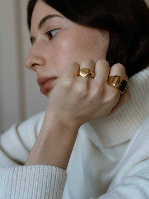 Free Close Up Photo of Woman Wearing Gold Rings Stock Photo