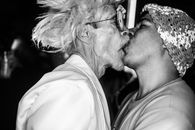 Man in White Shirt Kissing Woman in Black Shirt