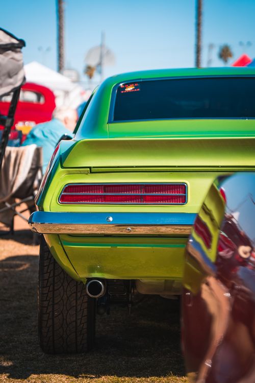 Free Bright green classic car tail view at an outdoor vehicle exhibition during daytime. Stock Photo