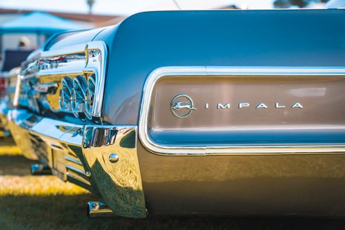 Free Detailed view of a classic Chevrolet Impala tail end showcasing emblem and chrome details. Stock Photo