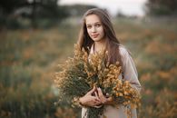 Woman Holding Armful of Flowers