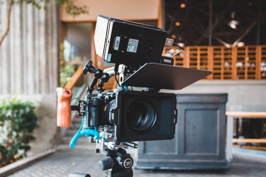 Close-up of a modern camera setup with a Rode monitor in a studio setting.