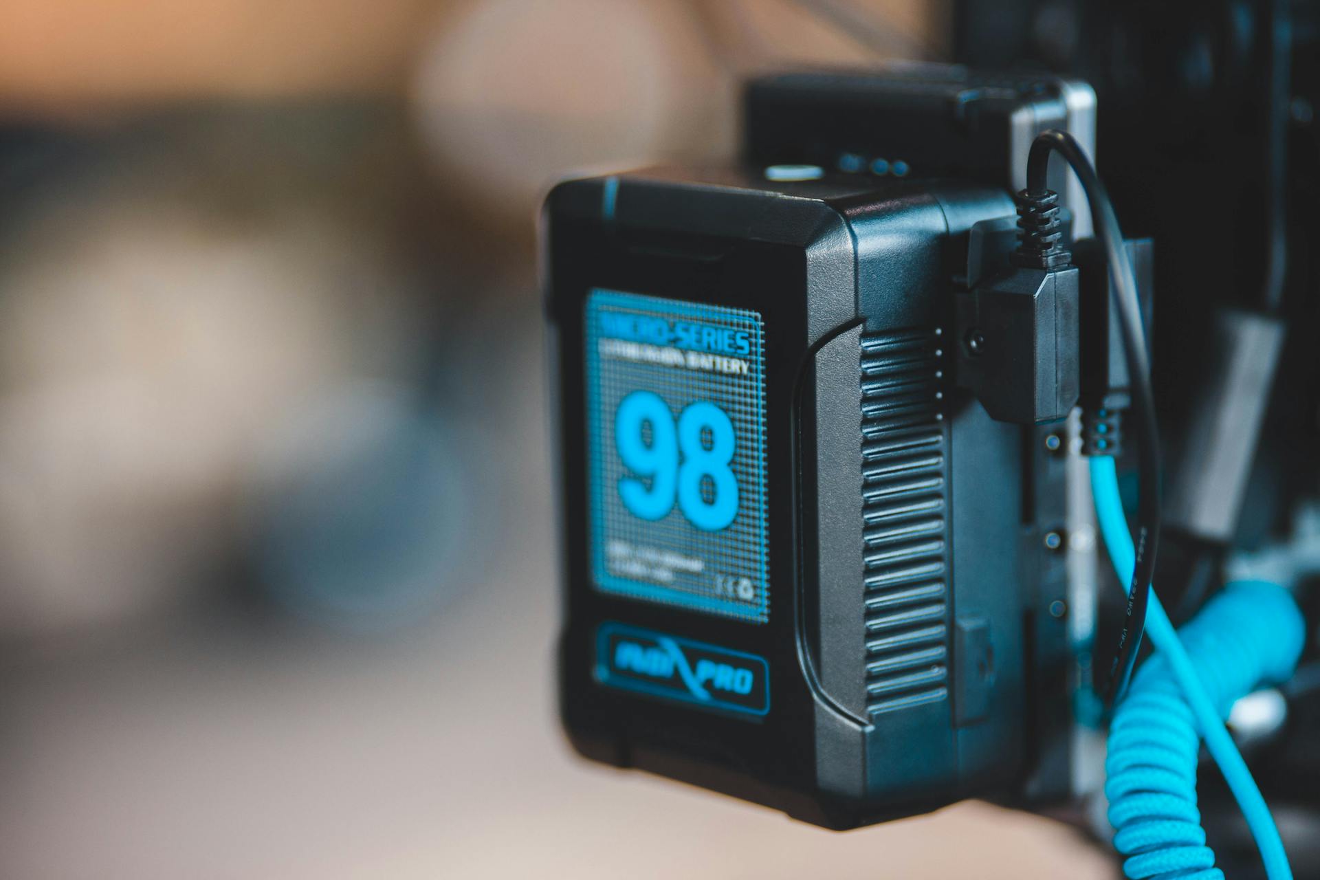 Close-up of a high-capacity portable battery with digital display showing 98 percent charge.