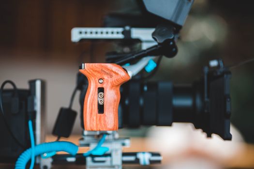 Close-up of a film camera with a wooden handgrip, ideal for videography gear lovers.