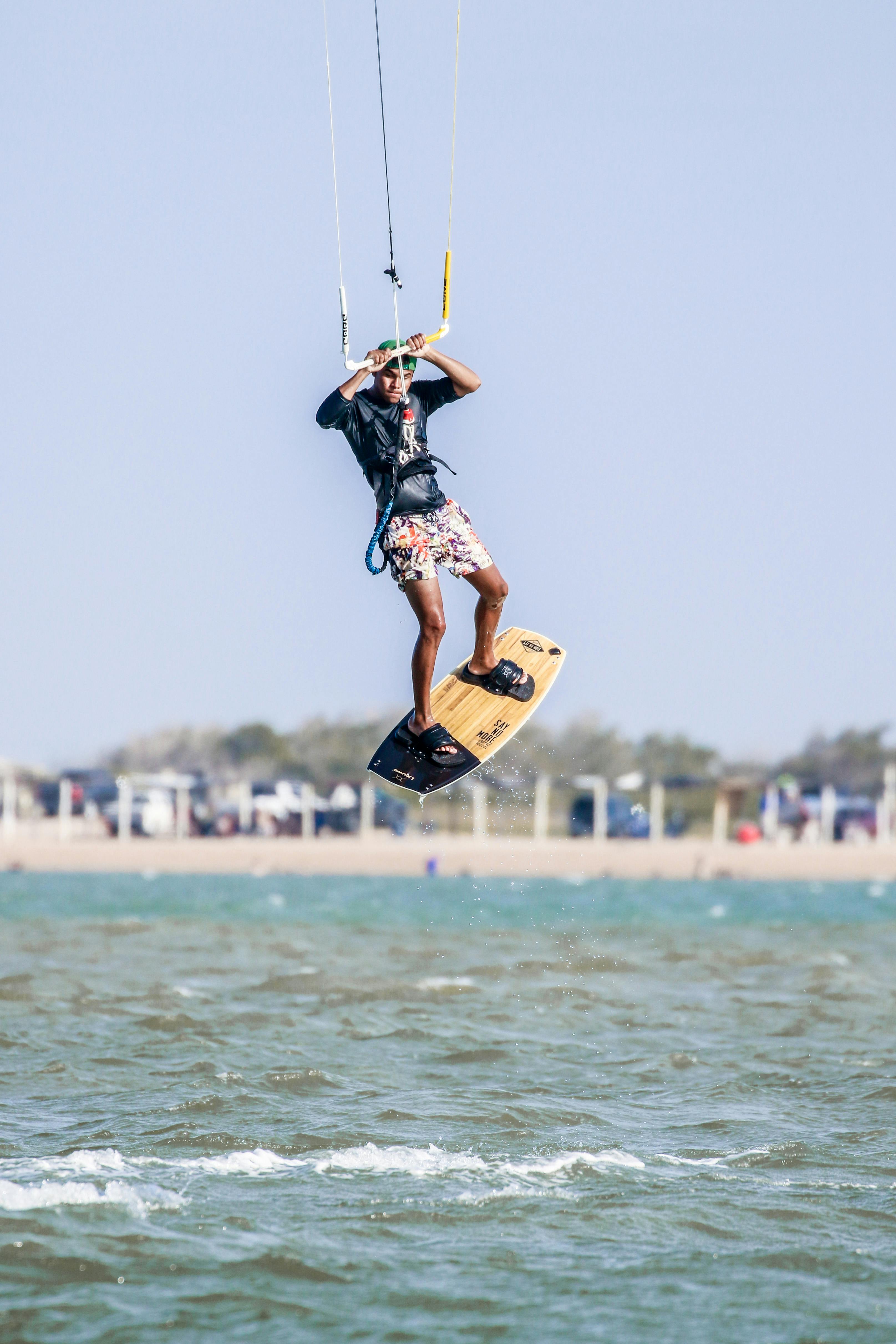 Man Holding Parachute With Wakeboard · Free Stock Photo