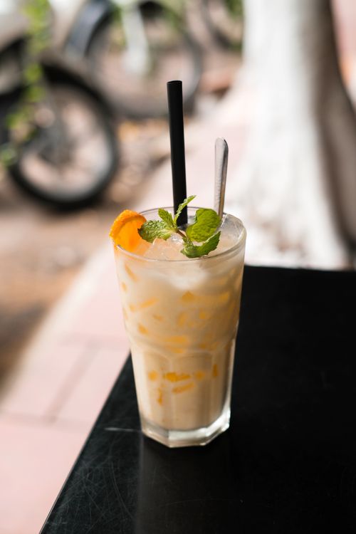 Free Chilled fruit cocktail with orange slices and mint on cafe table outdoors. Stock Photo