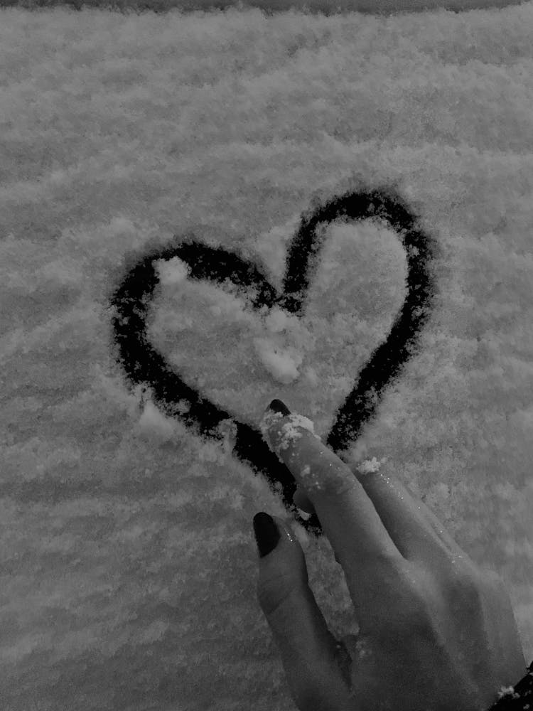 Person Drawing A Heart On Snow