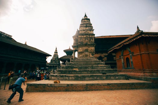 A captivating view of the historical Patan Durbar Square with tourists capturing its beauty.
