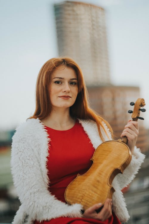 A Woman Holding a Violin