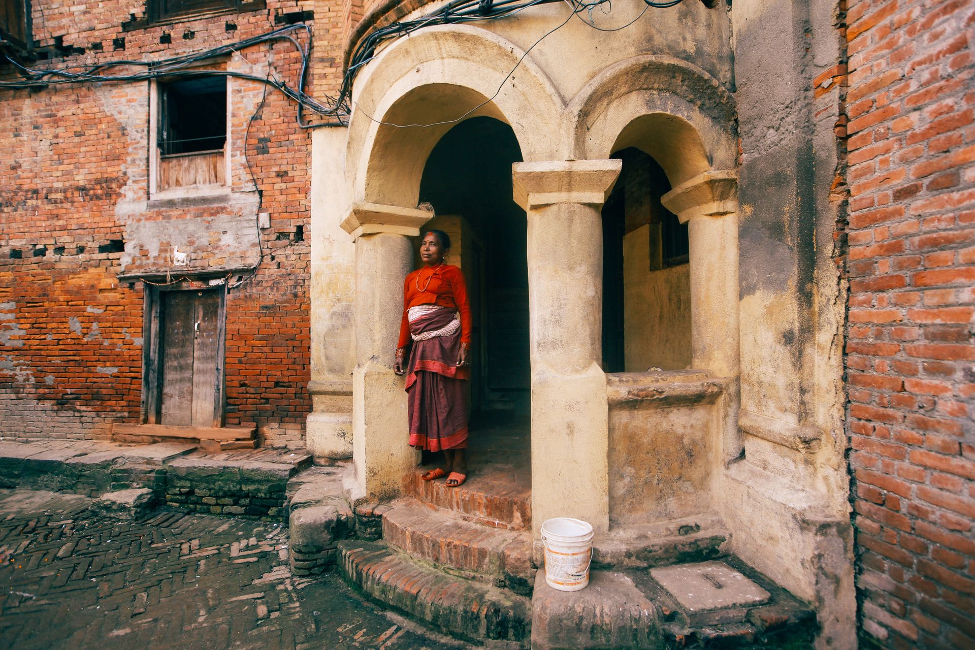 Woman Standing in Temple Entrance