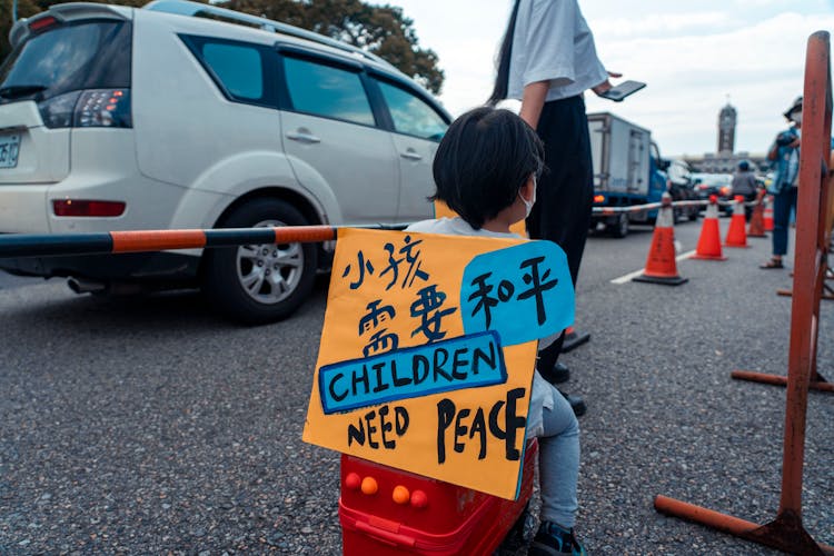 Child With A Banner On A Protest 