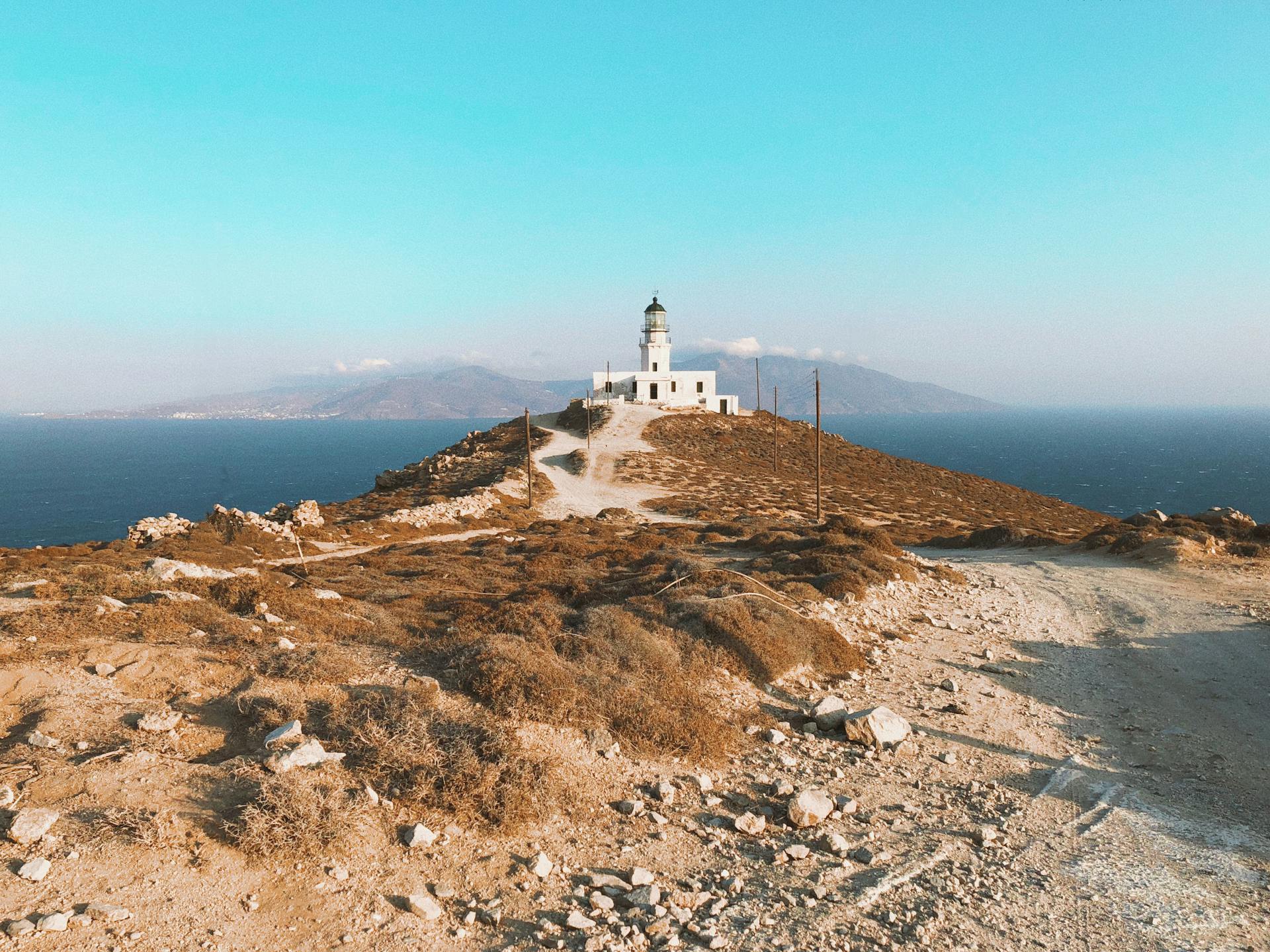 A breathtaking view of Armenistis Lighthouse on Mykonos overlooking the Aegean Sea.