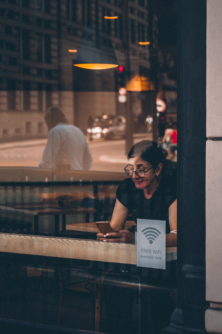 Woman Using A Smartphone Inside A Store